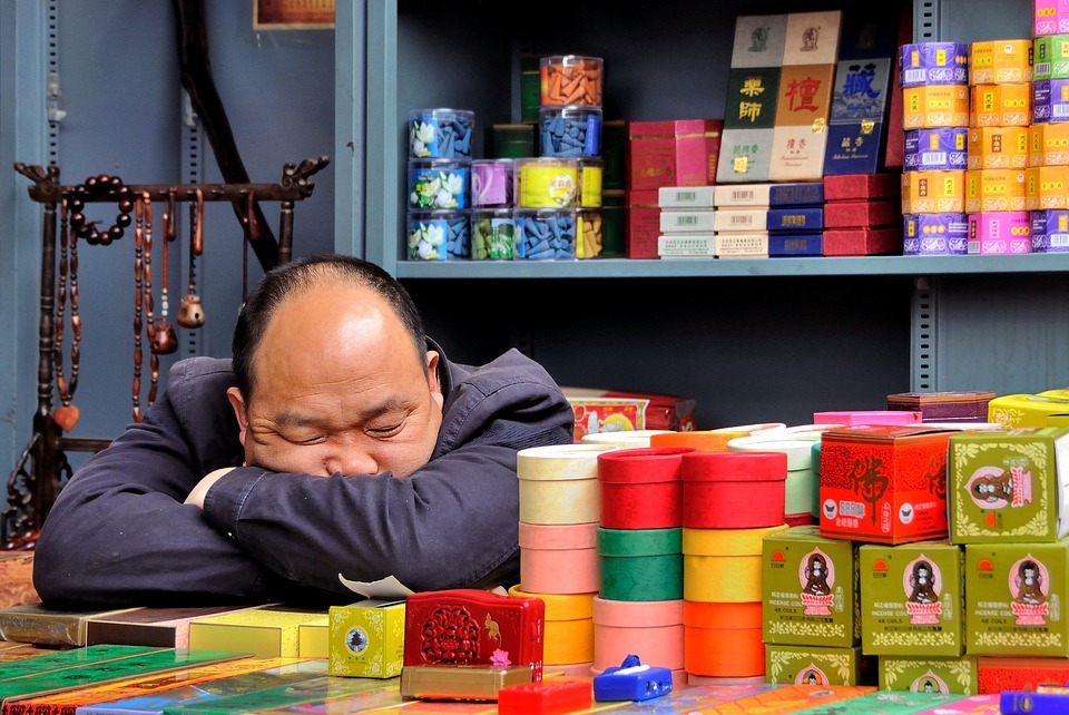 man sleeping on a table in a store