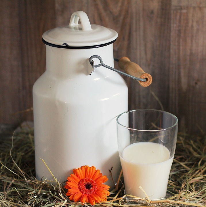 a glass of warm milk beside a jar