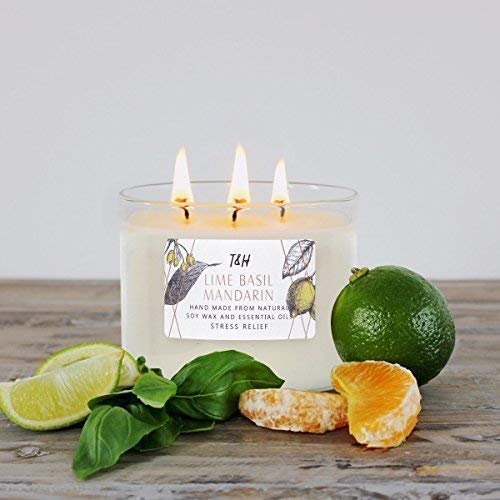a scented candle having a combination of lime, basil, and mandarin