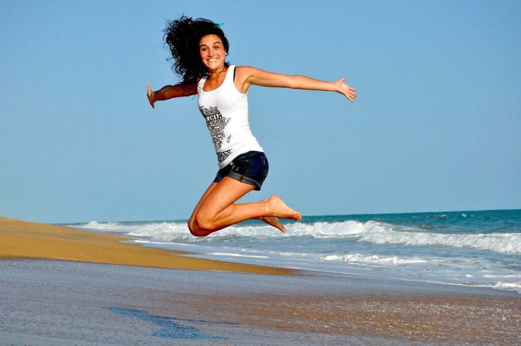 Woman Beach Jump Happy